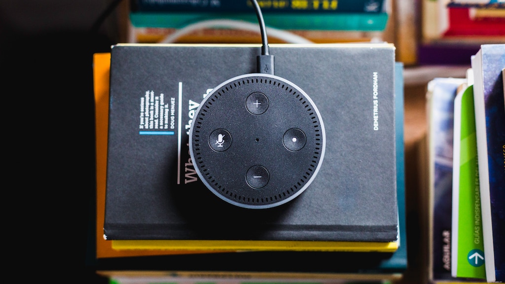 overhead photo of an Amazon Echo smart speaker on a pile of books