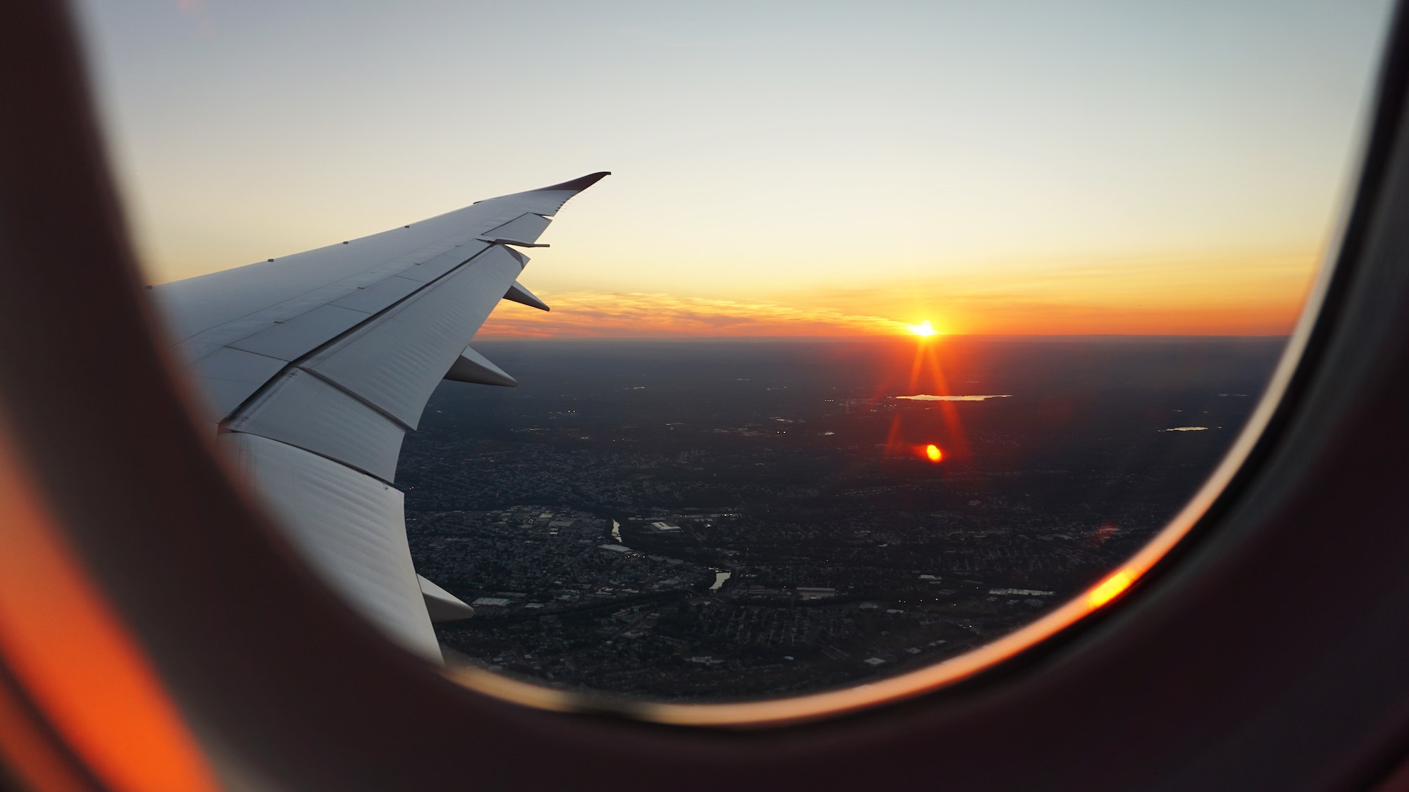 Photo of a sunset from a plane window