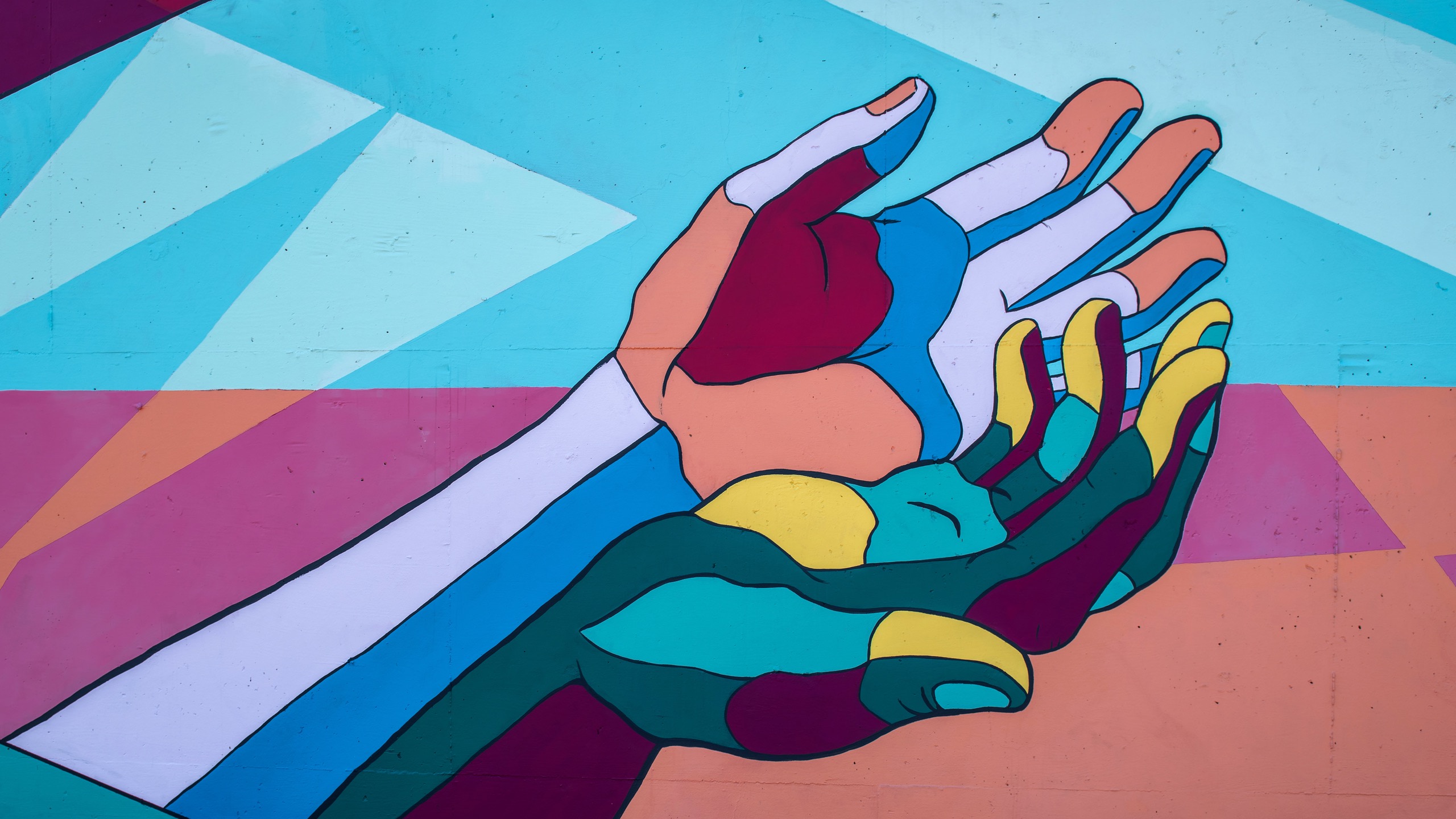 Artwork of two multicoloured hands reaching upwards