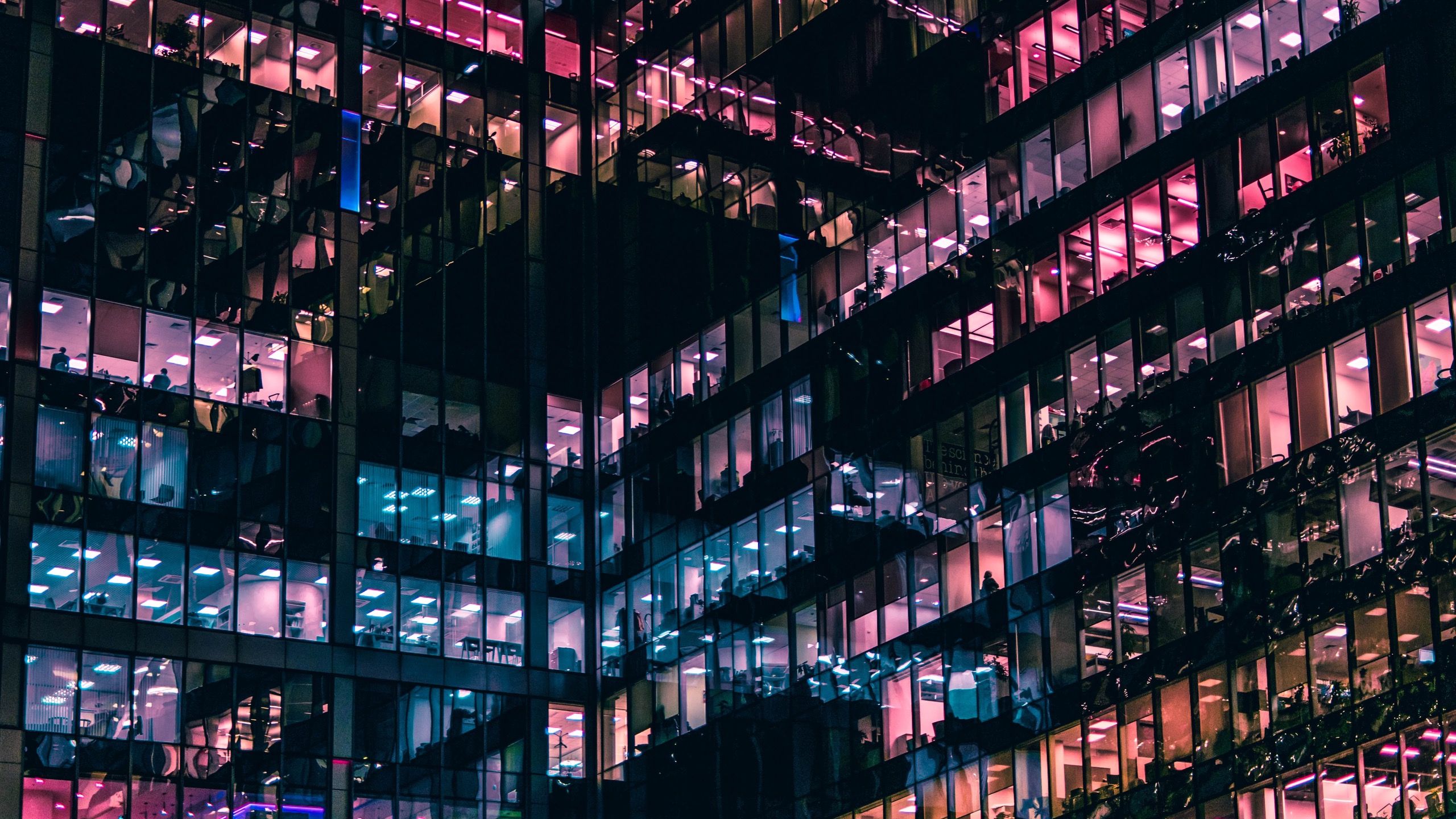 office building at night with multicoloured lights