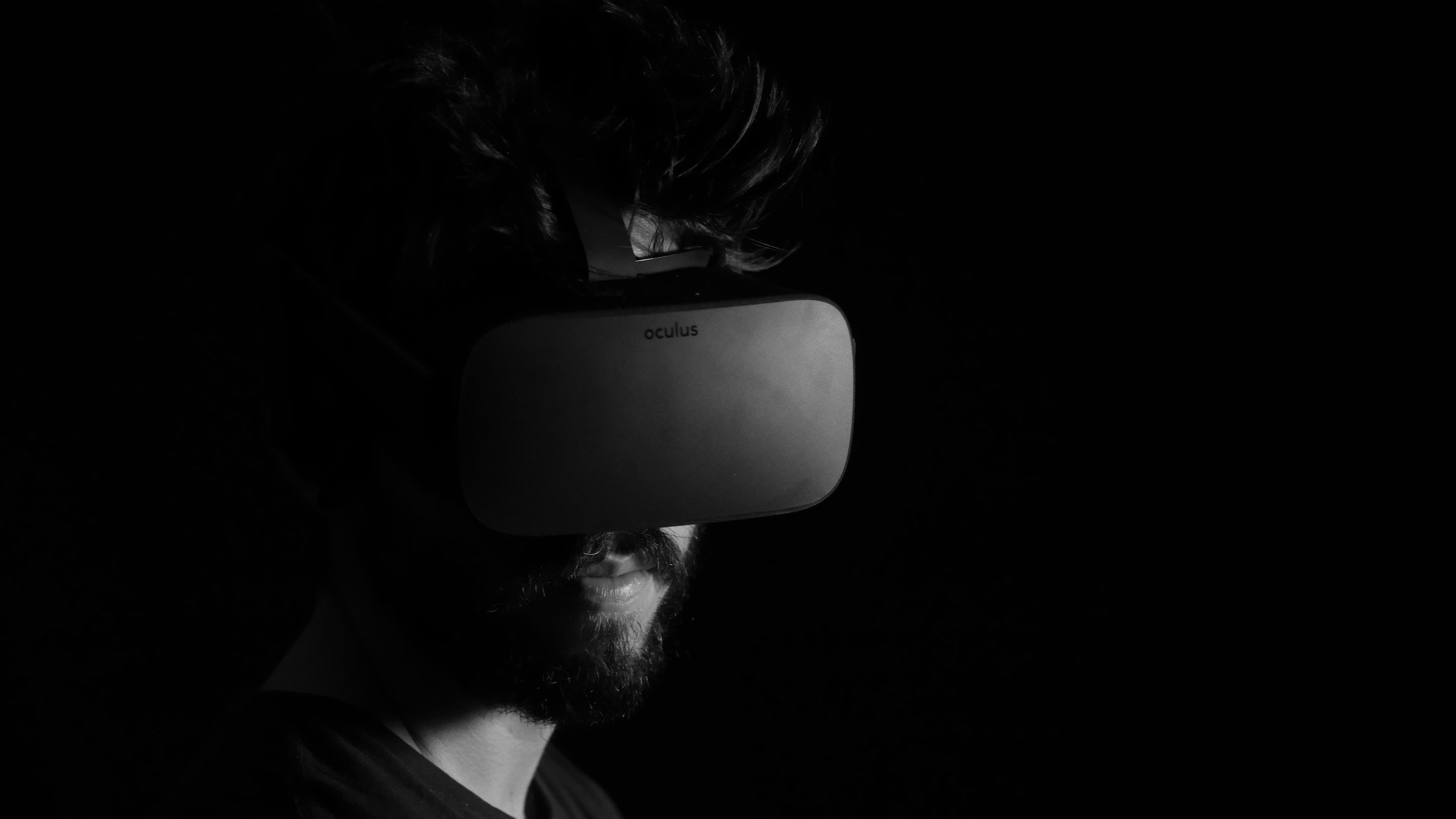 Person wearing a VR headset, their face is obscured by shadows
