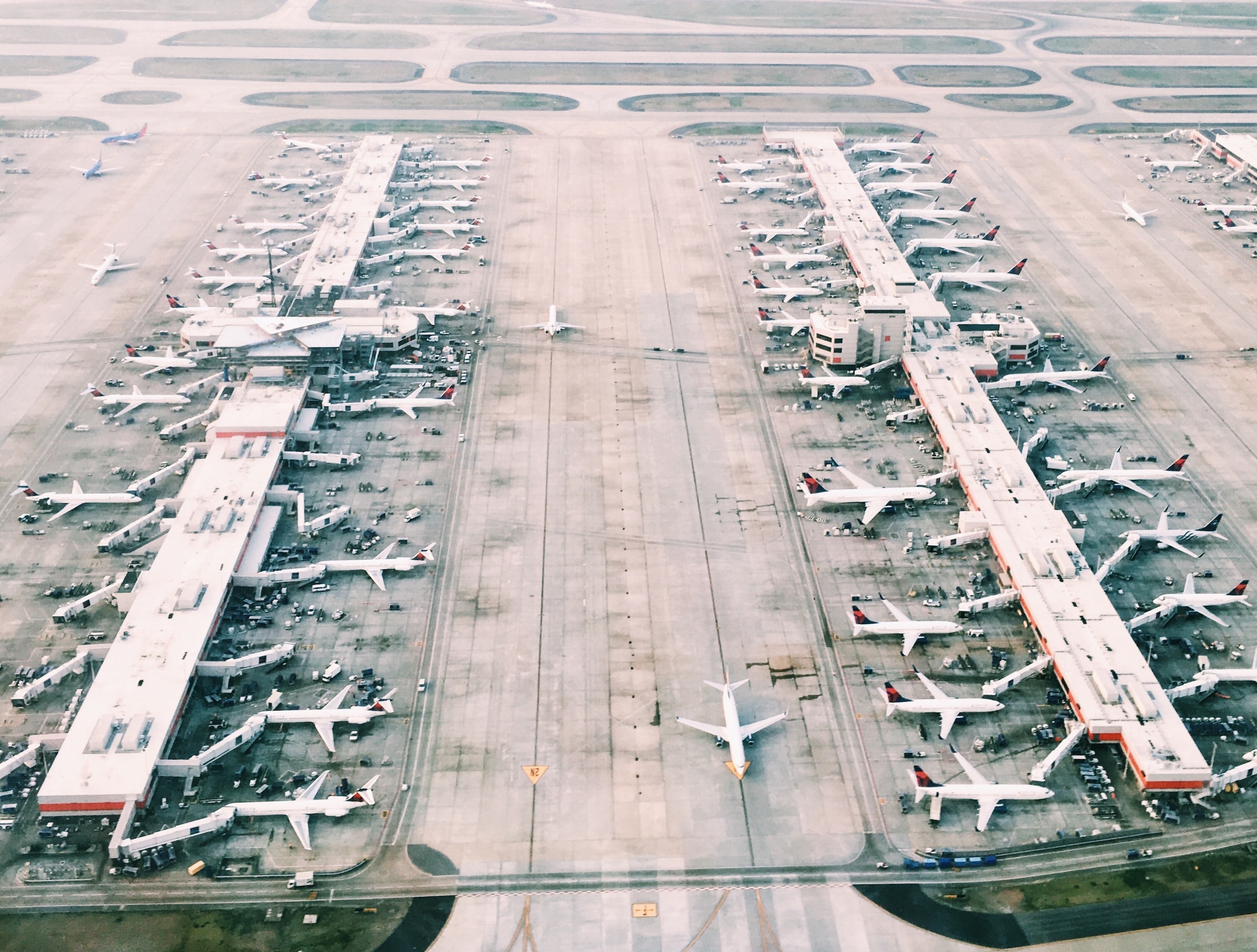 Aerial photo of an airport with planes lined up at terminals